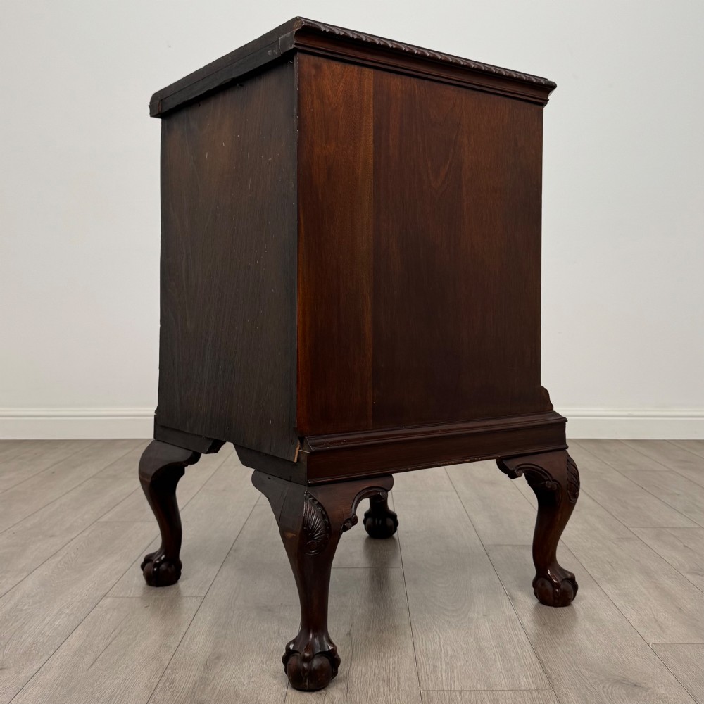 A dark mahogany Chippendale style cupboard featuring a single door with an oval flame mahogany panel, carved borders, and cabriole legs with ball-and-claw feet. View VII
