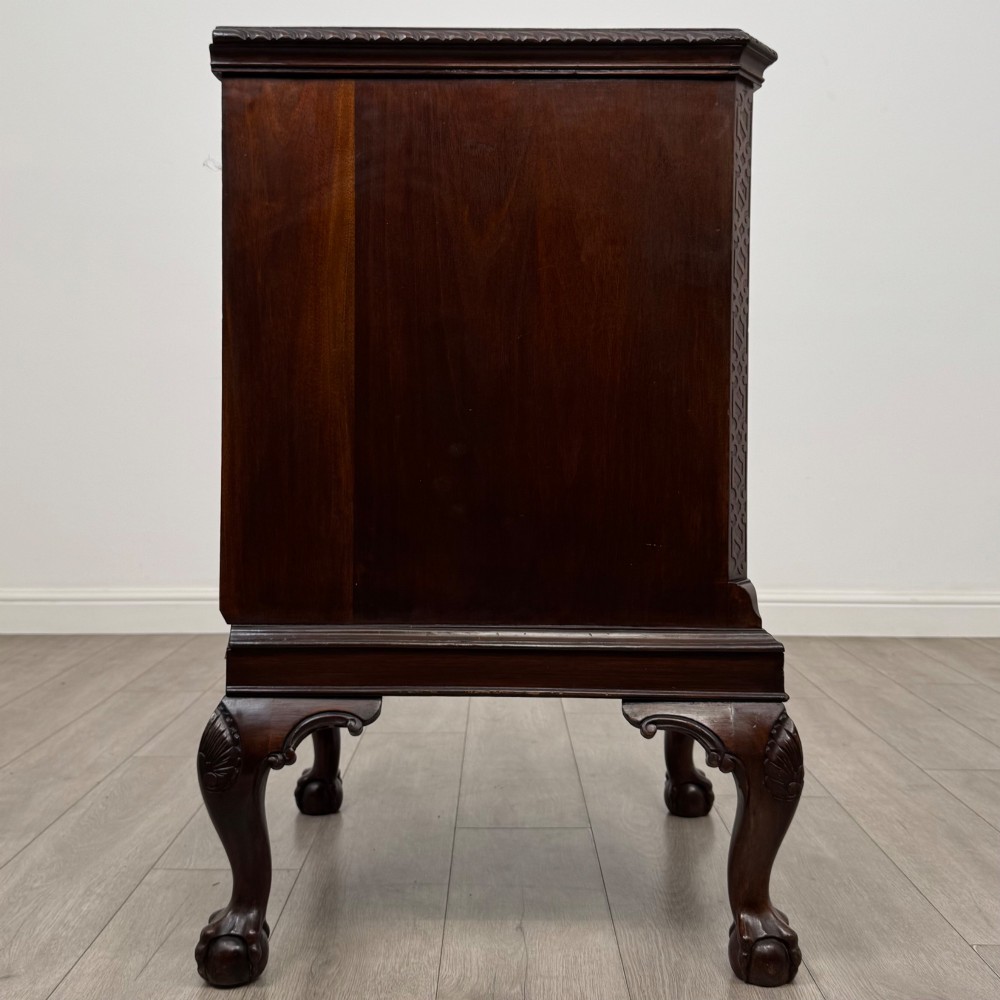 A dark mahogany Chippendale style cupboard featuring a single door with an oval flame mahogany panel, carved borders, and cabriole legs with ball-and-claw feet. View VIII