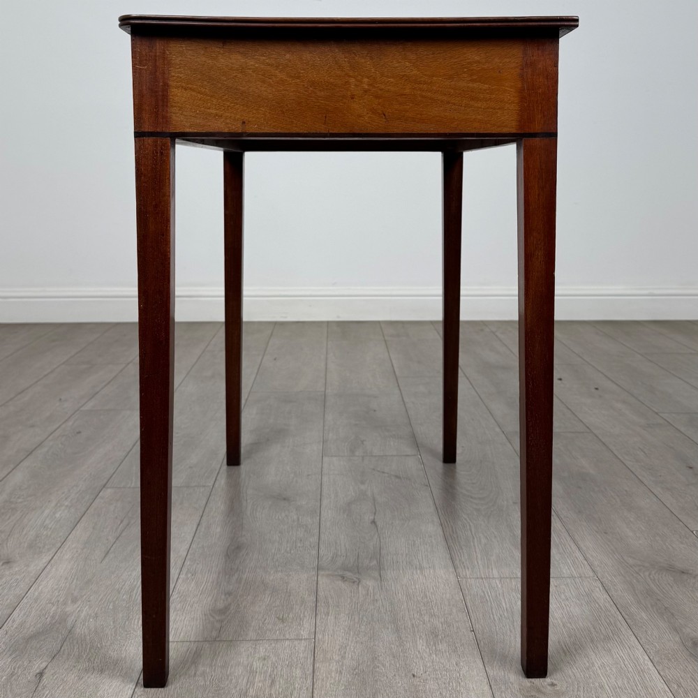 An 18th-century Georgian mahogany writing table featuring a single drawer with brass handles and four square tapered legs. View III