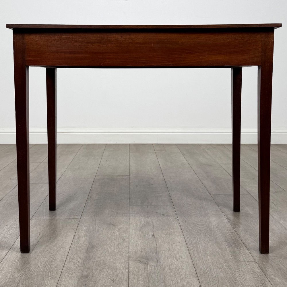 An 18th-century Georgian mahogany writing table featuring a single drawer with brass handles and four square tapered legs. View V