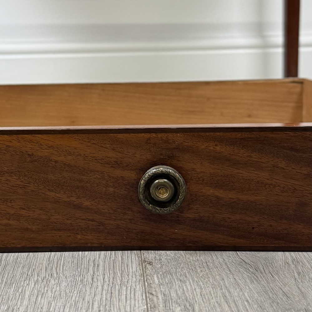 An 18th-century Georgian mahogany writing table featuring a single drawer with brass handles and four square tapered legs. View XI