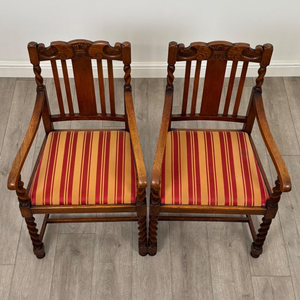 A set of ten early twentieth-century oak dining chairs featuring barley twist turned legs and supports with red and yellow striped upholstered seats. View IX