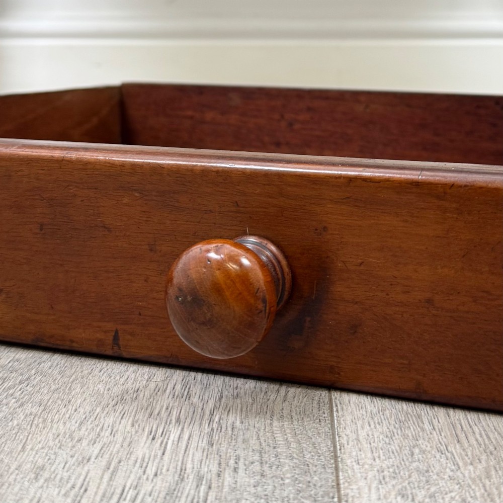 A Victorian mahogany writing table featuring two frieze drawers with wooden knobs and turned reeded legs. View XI
