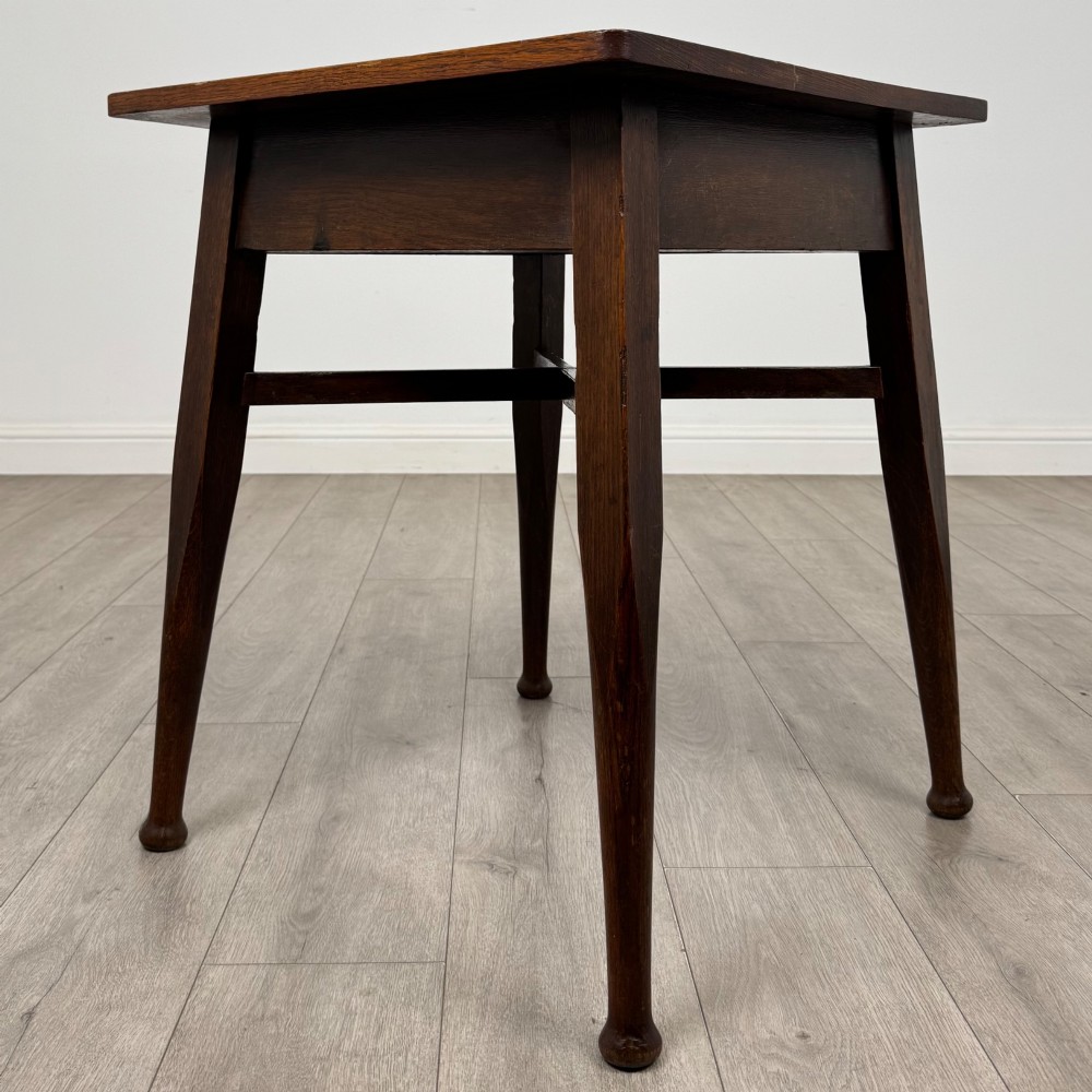 An antique dark oak Edwardian side table featuring four tapered legs, an X-shaped lower stretcher, and a square top surface. View II