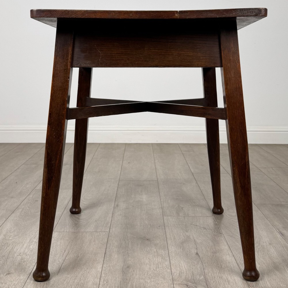 An antique dark oak Edwardian side table featuring four tapered legs, an X-shaped lower stretcher, and a square top surface. View VII