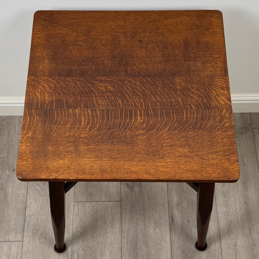 An antique dark oak Edwardian side table featuring four tapered legs, an X-shaped lower stretcher, and a square top surface. View IX