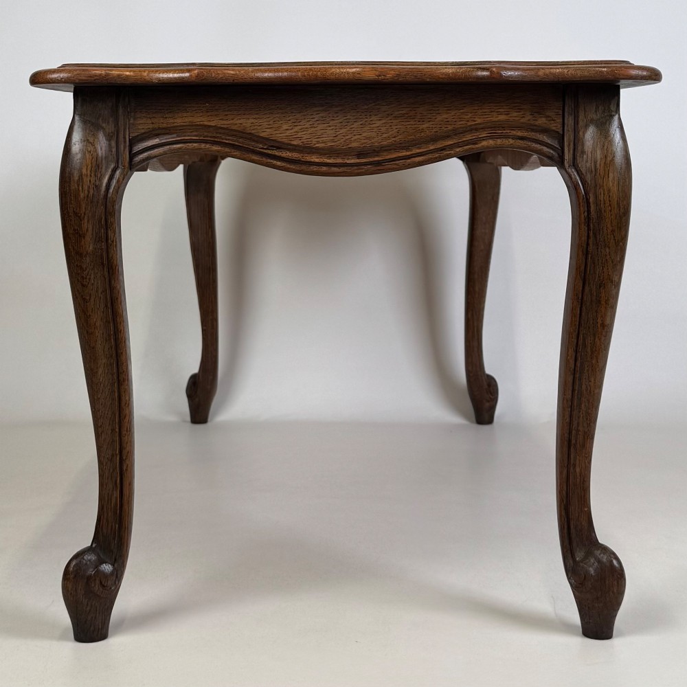 A 20th-century dark oak coffee table featuring cabriole legs, a serpentine apron, and a central carved shell motif. View III