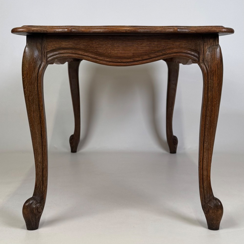 A 20th-century dark oak coffee table featuring cabriole legs, a serpentine apron, and a central carved shell motif. View VII