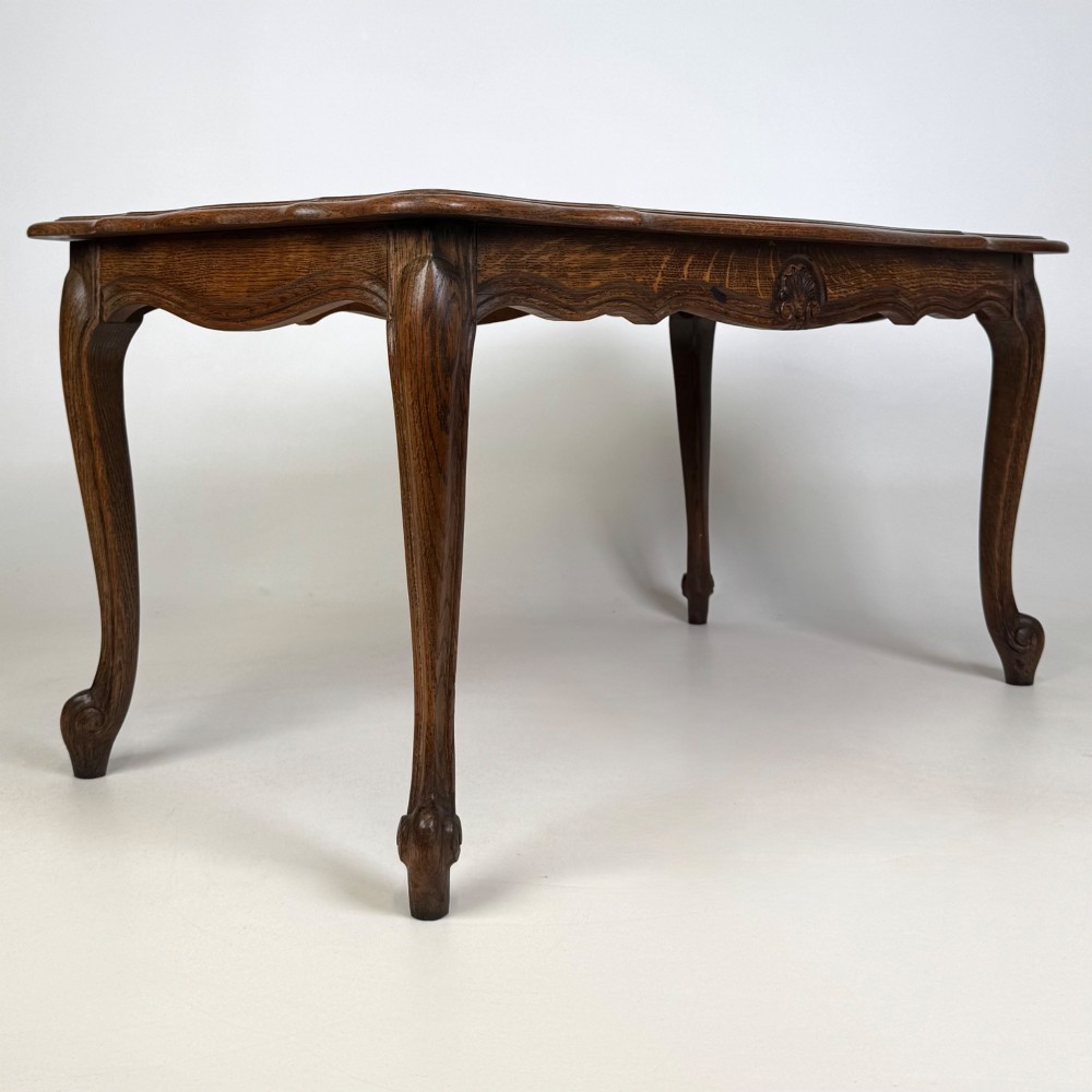 A 20th-century dark oak coffee table featuring cabriole legs, a serpentine apron, and a central carved shell motif. View VIII