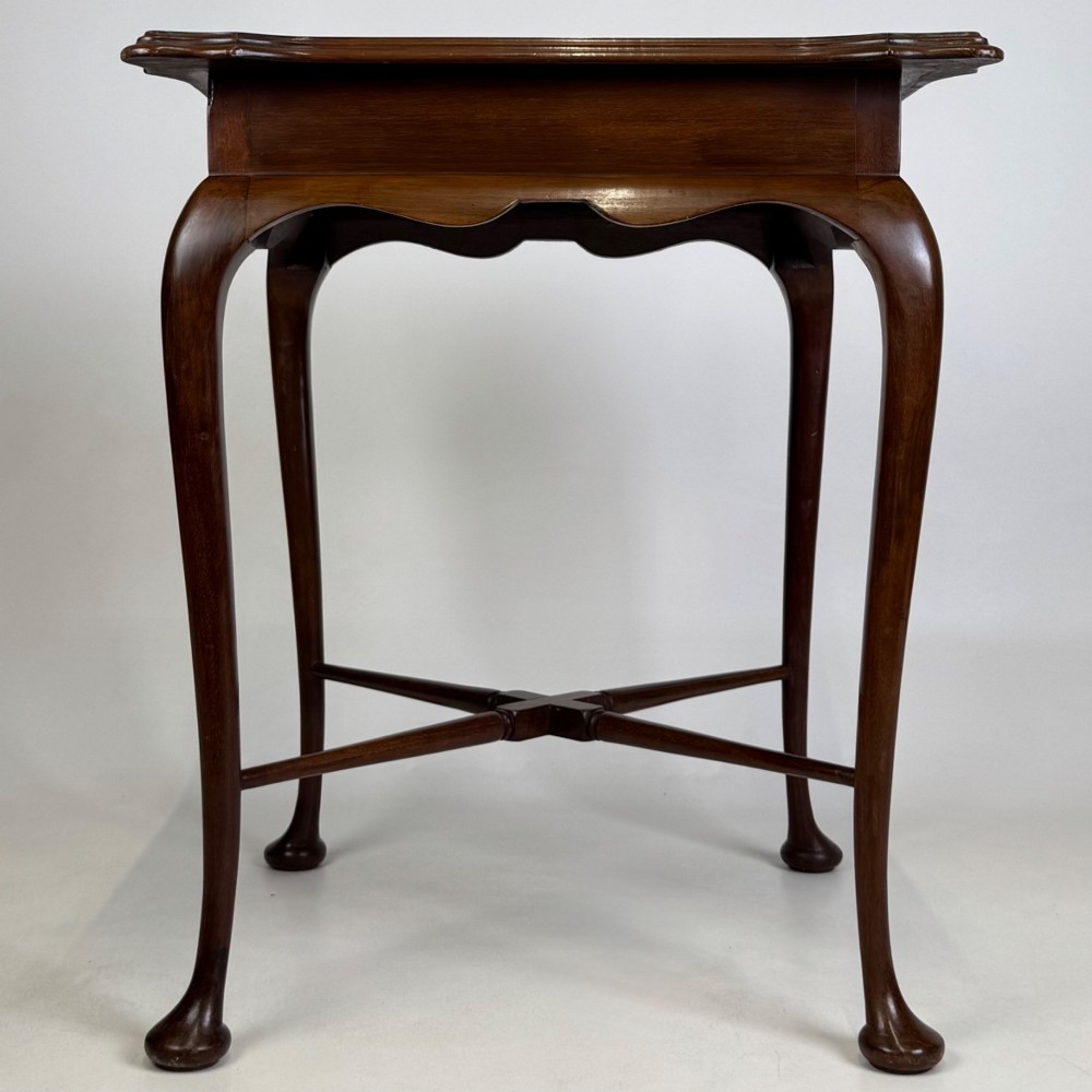An Edwardian mahogany side table featuring elegant cabriole legs, a shaped apron, and a central X-frame stretcher. View V