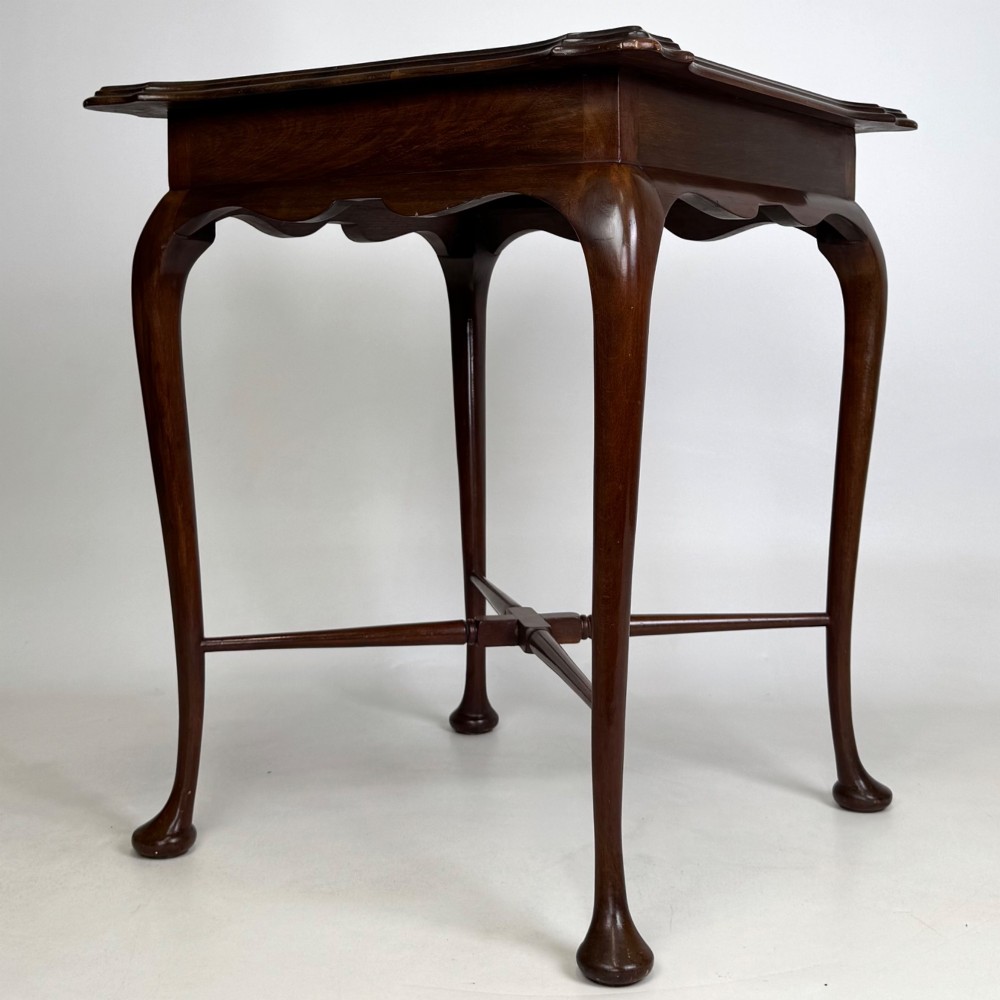 An Edwardian mahogany side table featuring elegant cabriole legs, a shaped apron, and a central X-frame stretcher. View VIII