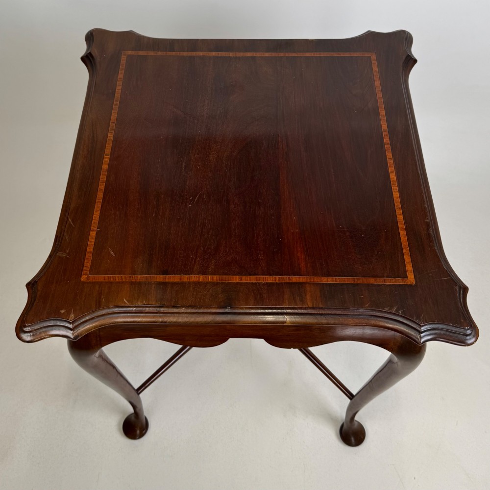 An Edwardian mahogany side table featuring elegant cabriole legs, a shaped apron, and a central X-frame stretcher. View IX
