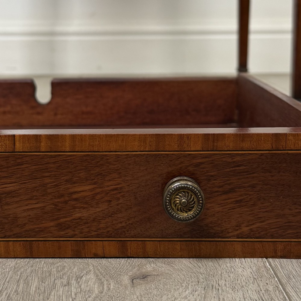 An Edwardian mahogany envelope card table with crossbanded satinwood inlay, a single drawer, and tapered square legs on brass castors. View XIII