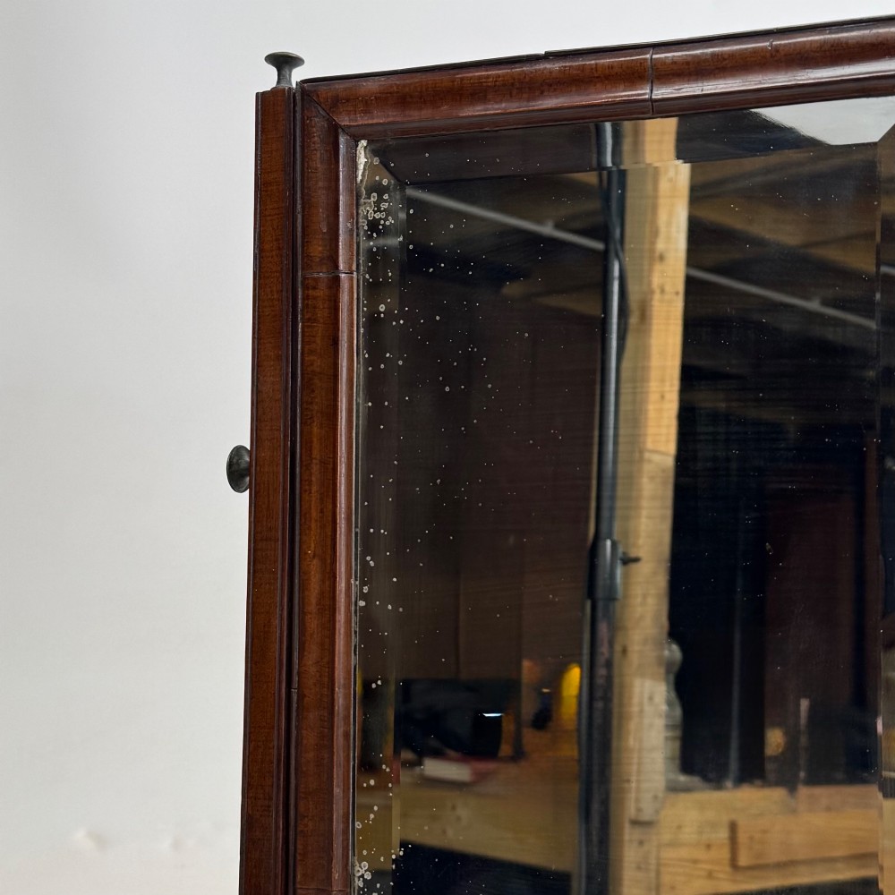 An 18th-century Georgian mahogany dressing mirror featuring an adjustable rectangular tilting glass plate supported above a shaped box base containing three small drawers. View XIII