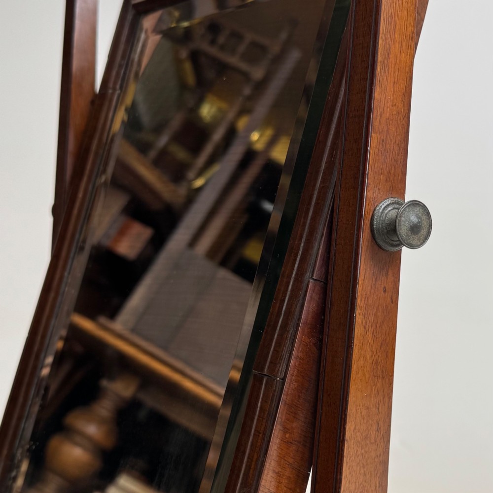 An 18th-century Georgian mahogany dressing mirror featuring an adjustable rectangular tilting glass plate supported above a shaped box base containing three small drawers. View XIV