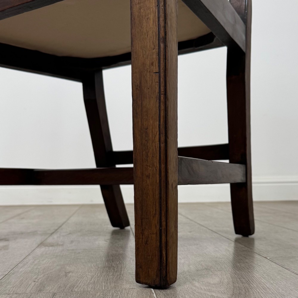 A set of six Georgian mahogany dining chairs featuring intricate carved pierced splat backs, square legs, and light green patterned upholstered seats. View VI