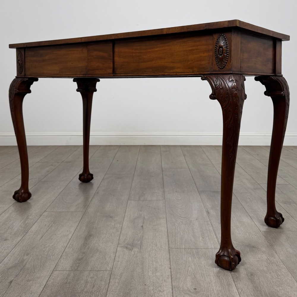 A 19th-century Chippendale style mahogany side table featuring carved cabriole legs ending in ball and claw feet. View II