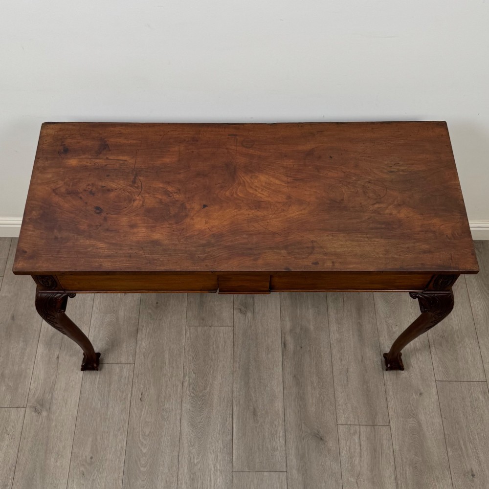 A 19th-century Chippendale style mahogany side table featuring carved cabriole legs ending in ball and claw feet. View IX