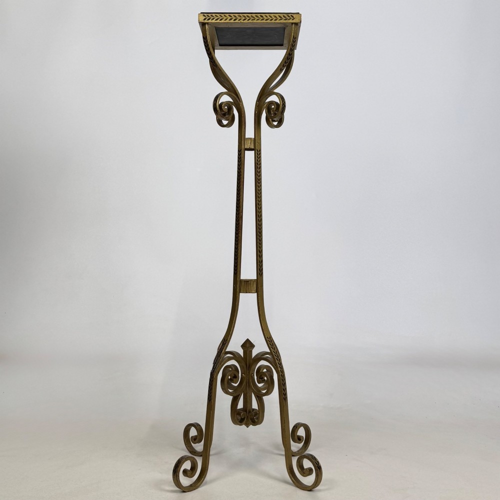 A pair of tall gilded metal plant stands featuring incised leaf patterning, scrollwork legs, and square dark marble tops. View VI