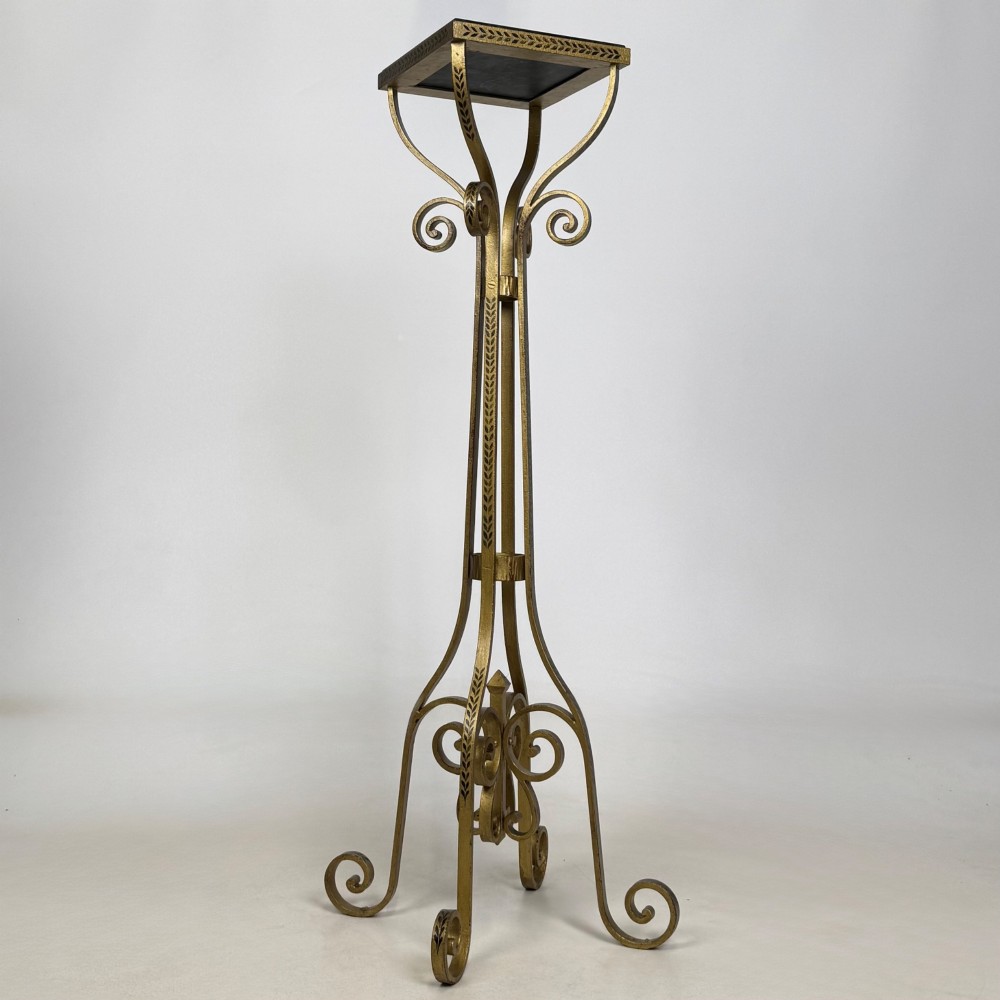 A pair of tall gilded metal plant stands featuring incised leaf patterning, scrollwork legs, and square dark marble tops. View VII