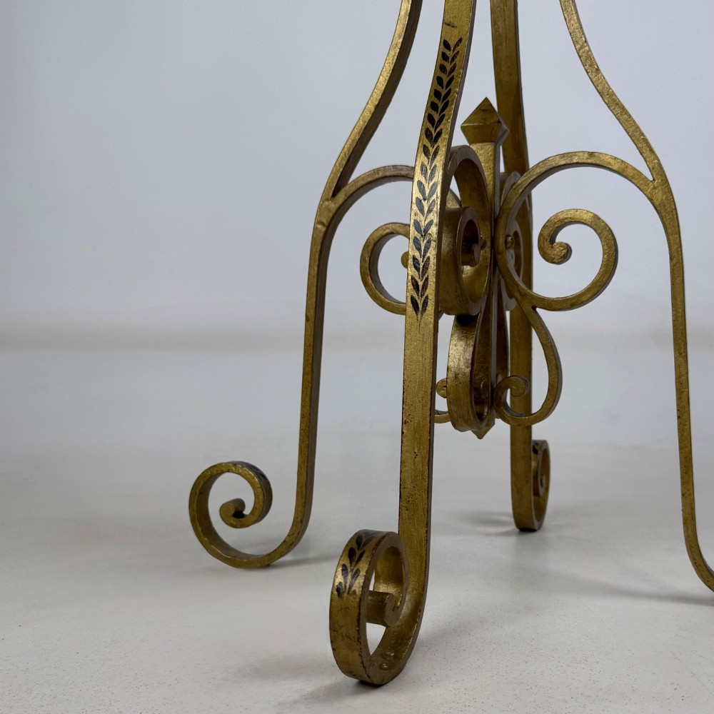 A pair of tall gilded metal plant stands featuring incised leaf patterning, scrollwork legs, and square dark marble tops. View X