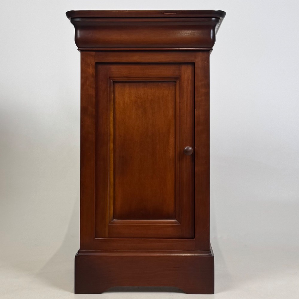 A matching pair of 20th-century mahogany bedside cabinets featuring single panelled doors, turned wooden handles, moulded cornices, and solid plinth bases. View II