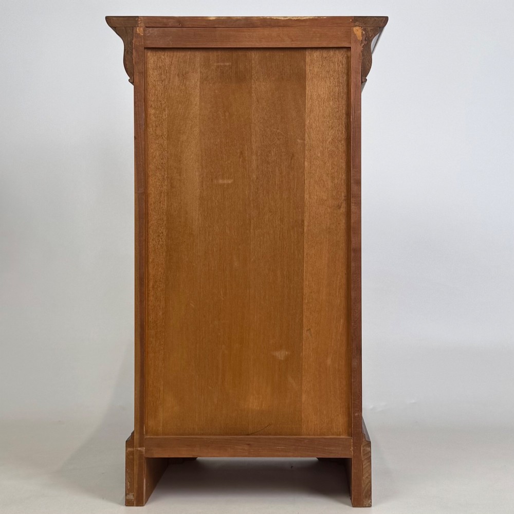 A matching pair of 20th-century mahogany bedside cabinets featuring single panelled doors, turned wooden handles, moulded cornices, and solid plinth bases. View VII