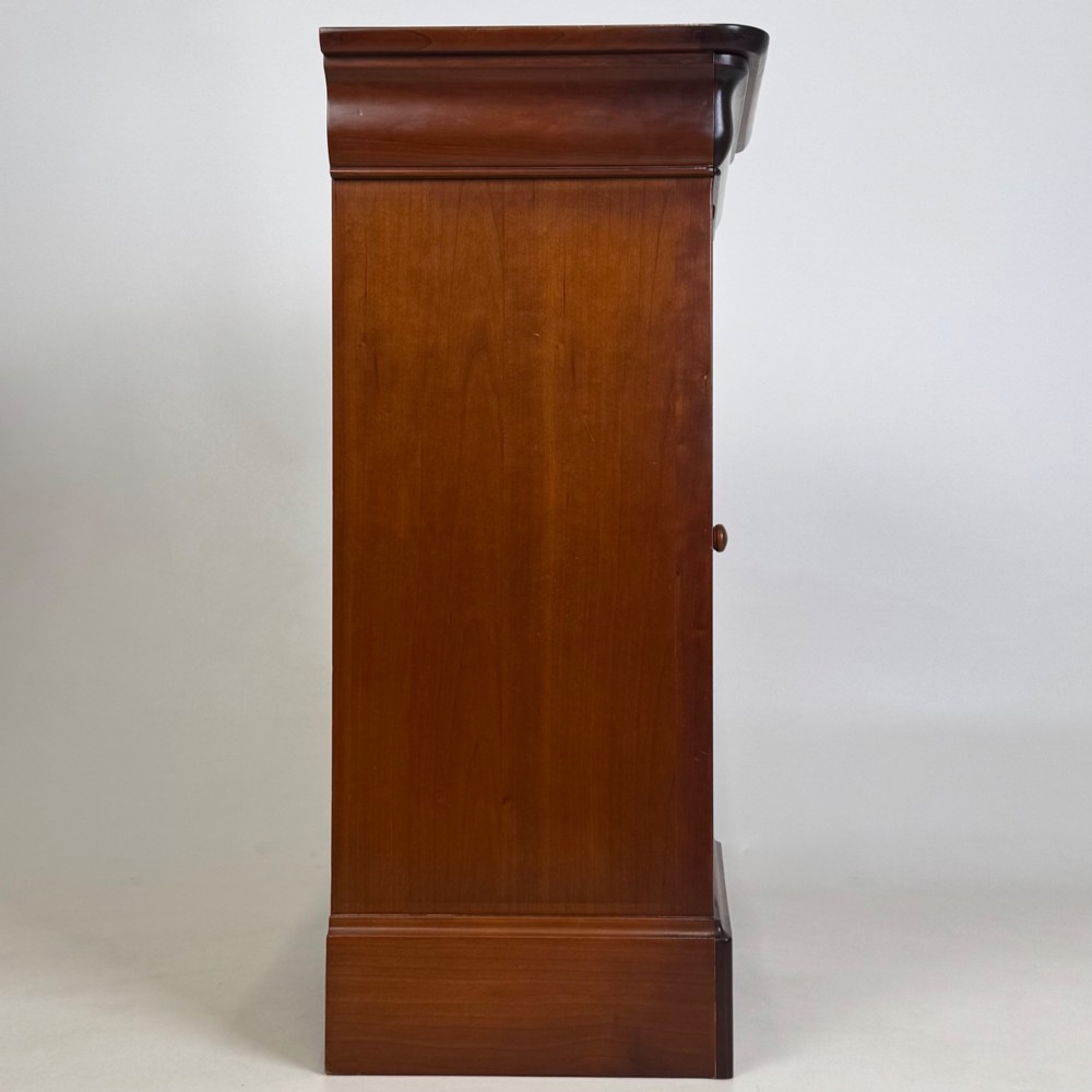 A matching pair of 20th-century mahogany bedside cabinets featuring single panelled doors, turned wooden handles, moulded cornices, and solid plinth bases. View IX