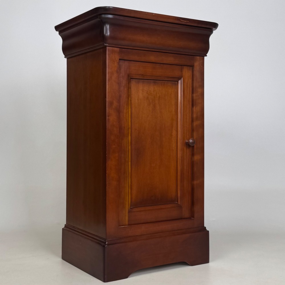 A matching pair of 20th-century mahogany bedside cabinets featuring single panelled doors, turned wooden handles, moulded cornices, and solid plinth bases. View X