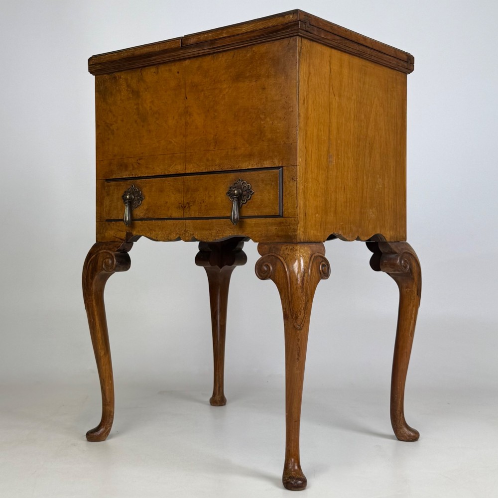An Edwardian burr walnut cabinet resting on slender cabriole legs with ornate brass drop handles. View II