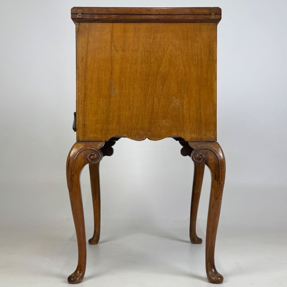 An Edwardian burr walnut cabinet resting on slender cabriole legs with ornate brass drop handles. View III
