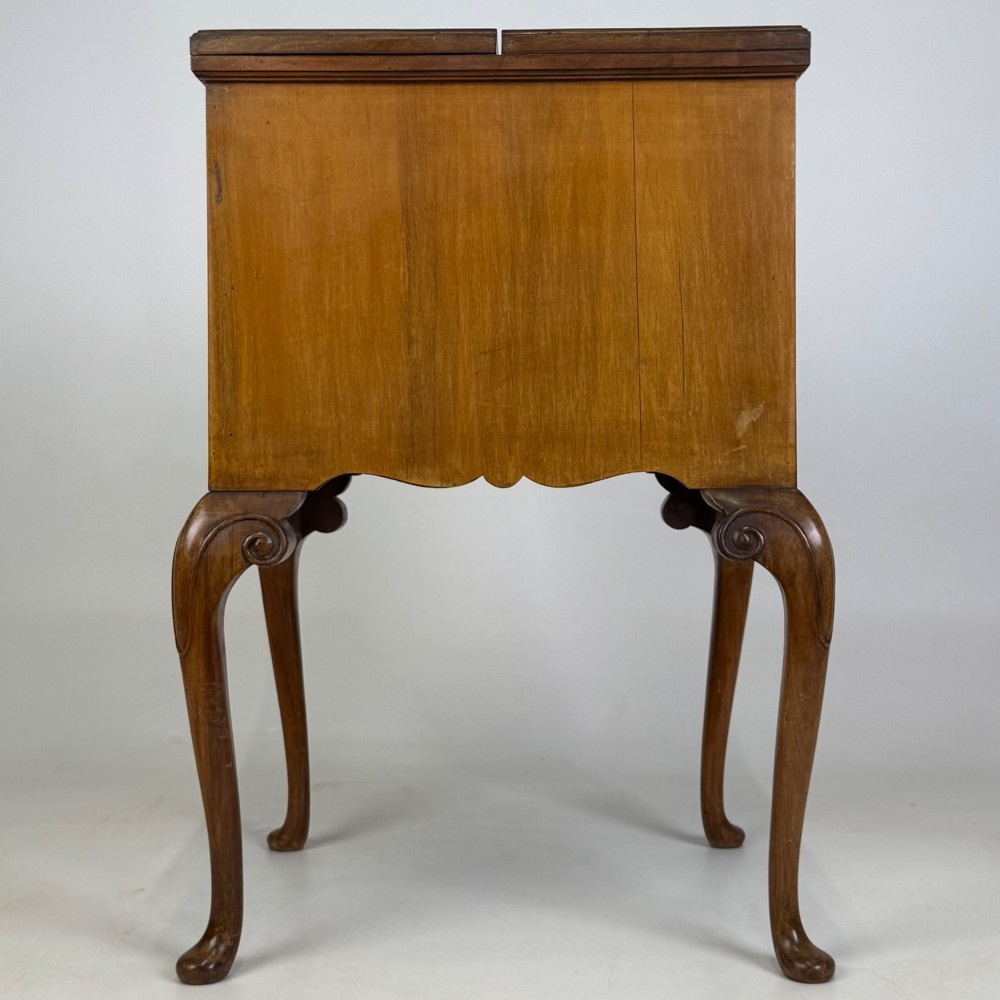 An Edwardian burr walnut cabinet resting on slender cabriole legs with ornate brass drop handles. View V