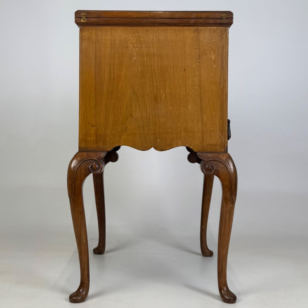 An Edwardian burr walnut cabinet resting on slender cabriole legs with ornate brass drop handles. View VII
