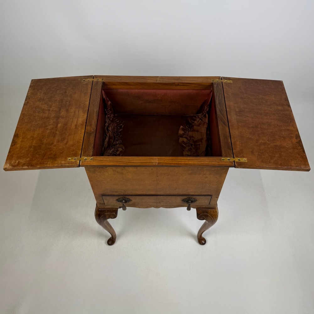 An Edwardian burr walnut cabinet resting on slender cabriole legs with ornate brass drop handles. View XI