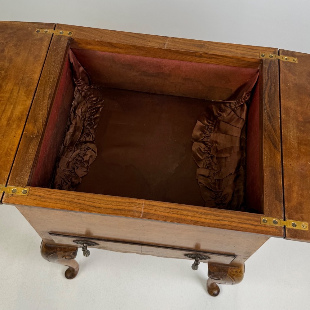 An Edwardian burr walnut cabinet resting on slender cabriole legs with ornate brass drop handles. View XII