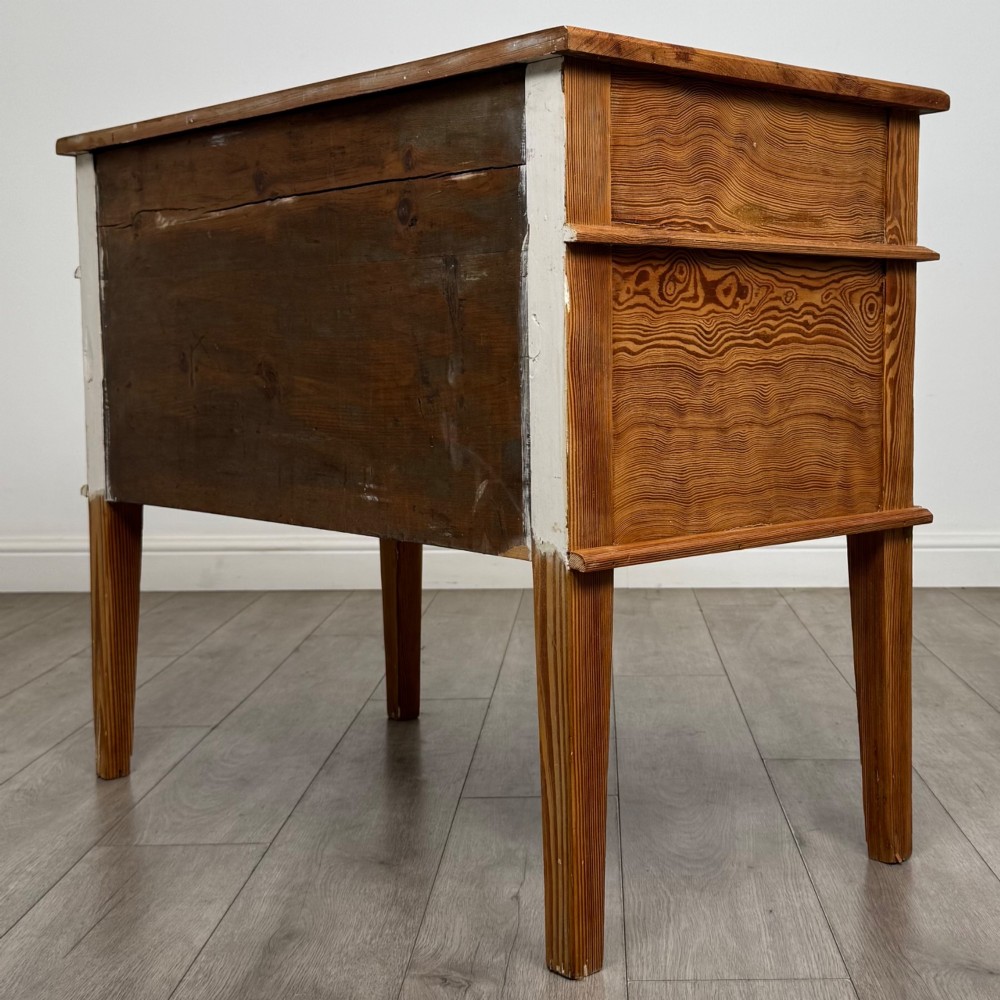 A Victorian pitch pine cupboard featuring a single top drawer over two cupboard doors with diagonal timber panels and straight tapered legs. View VII