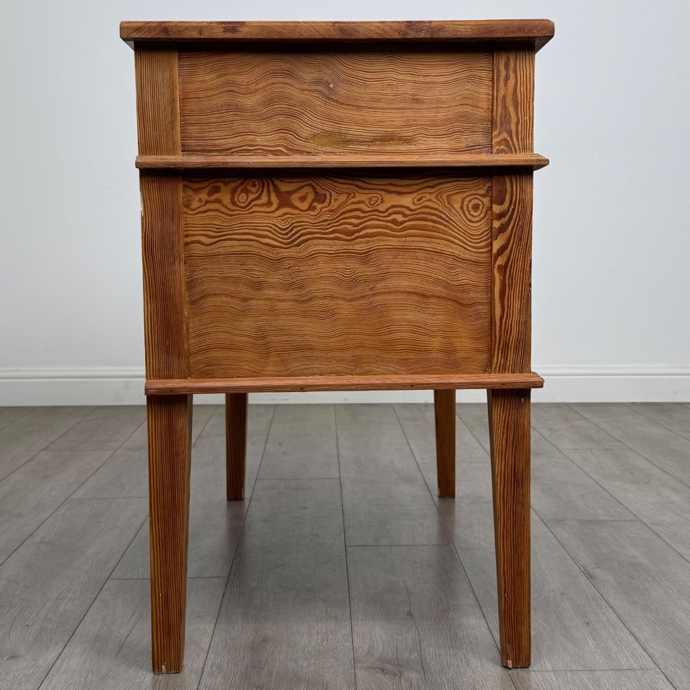 A Victorian pitch pine cupboard featuring a single top drawer over two cupboard doors with diagonal timber panels and straight tapered legs. View VIII