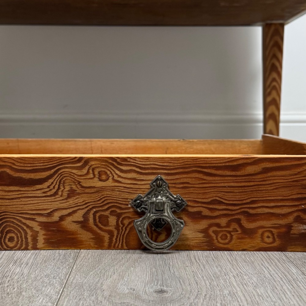 A Victorian pitch pine cupboard featuring a single top drawer over two cupboard doors with diagonal timber panels and straight tapered legs. View XII