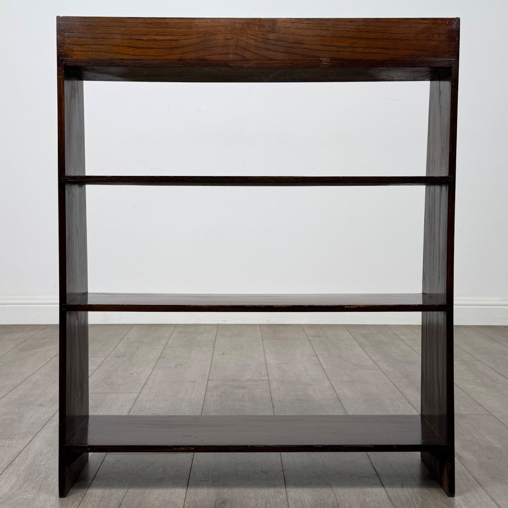 A dark oak Edwardian open bookcase with four horizontal shelves holding leather-bound books. View VI