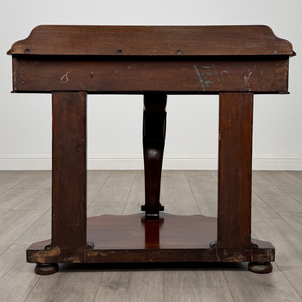 A 19th-century Victorian mahogany washstand featuring a carved central leg, shaped top, and contoured plinth base. View V
