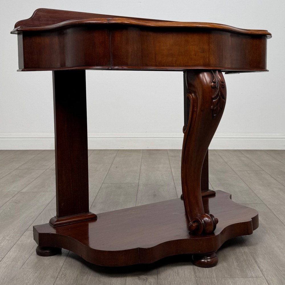 A 19th-century Victorian mahogany washstand featuring a carved central leg, shaped top, and contoured plinth base. View VIII