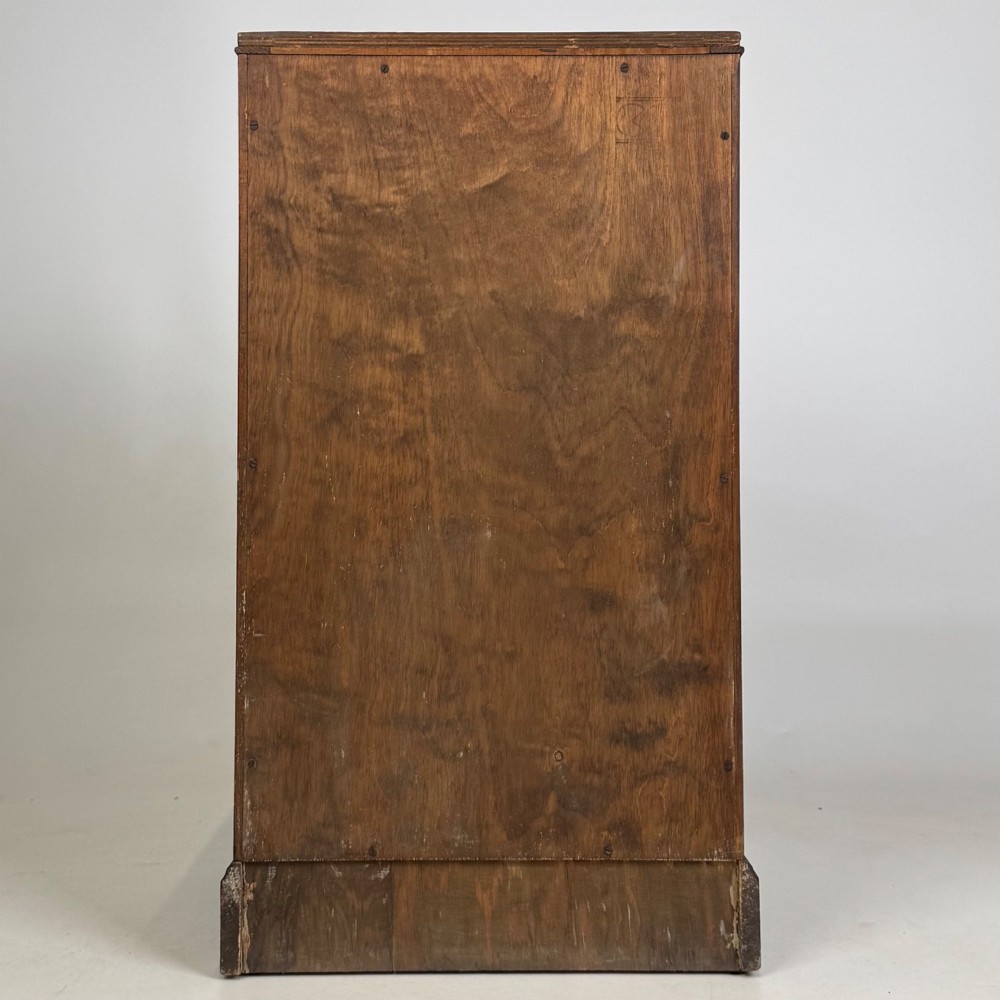 A standing antique dark oak bedside cabinet with a single framed door, a round carved handle, and a solid plinth base. View VI