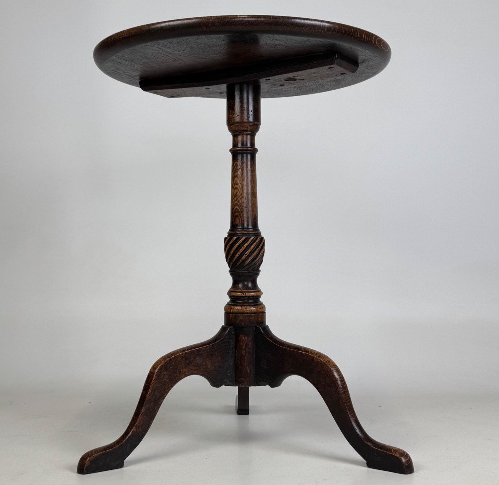 A 19th-century dark oak circular side table featuring a turned pedestal with spiral carving on a tripod base. View II
