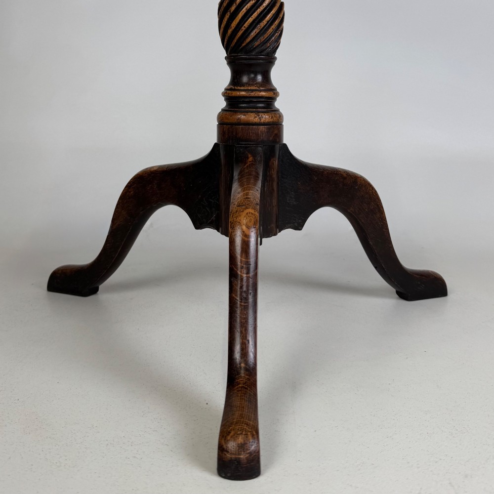 A 19th-century dark oak circular side table featuring a turned pedestal with spiral carving on a tripod base. View IV