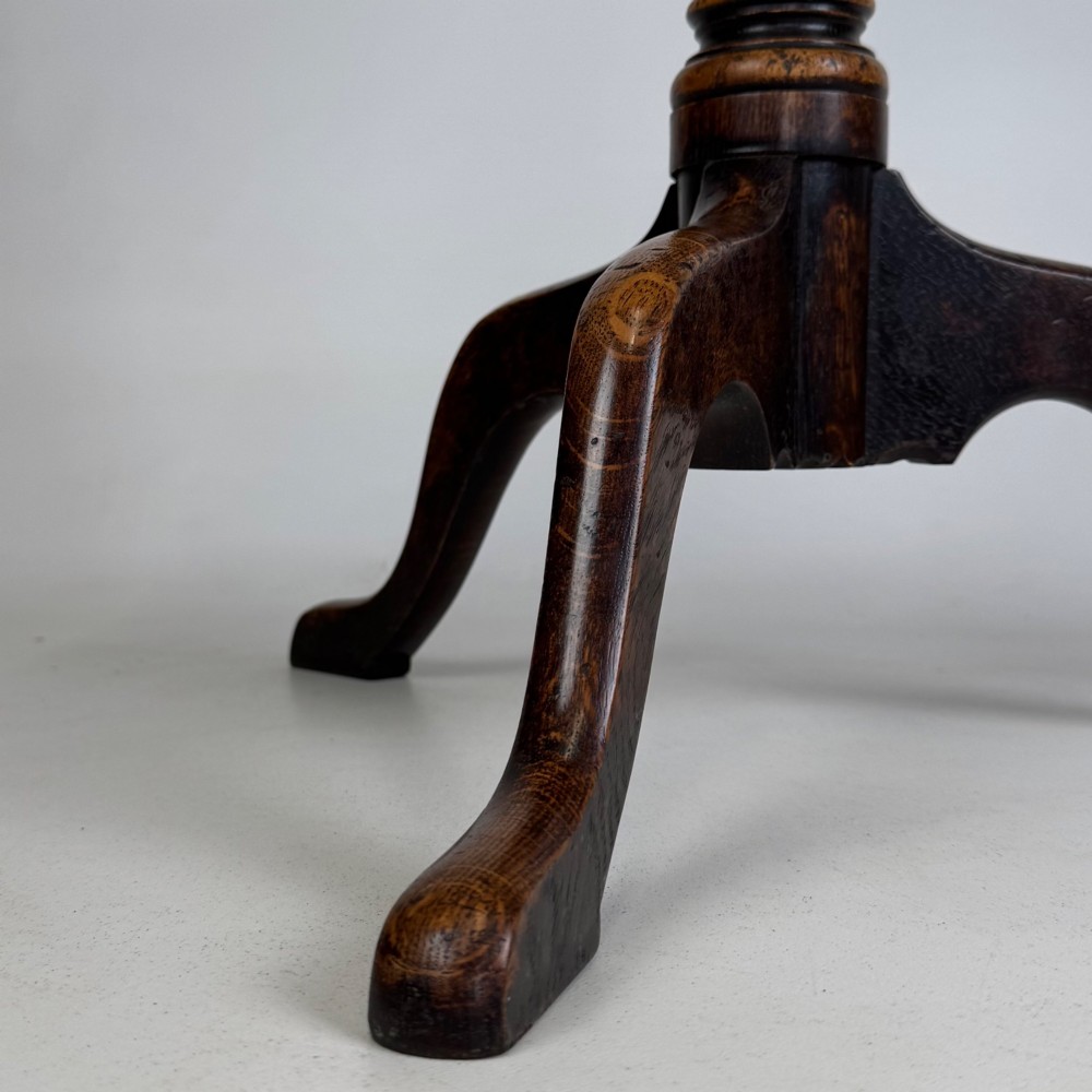 A 19th-century dark oak circular side table featuring a turned pedestal with spiral carving on a tripod base. View V