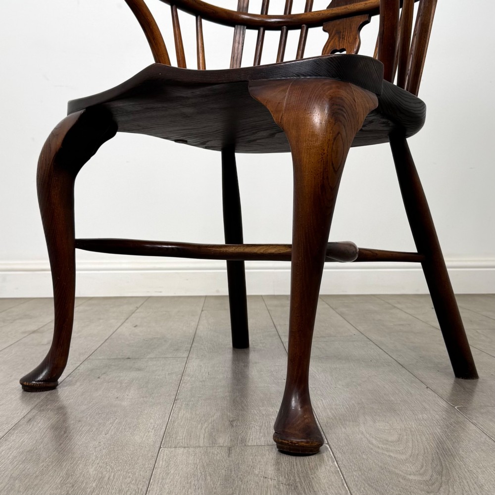 A pair of warm brown elm Windsor armchairs featuring shaped top rails, pierced back splats, spindle supports, shaped saddle seats, and front cabriole legs. View XI