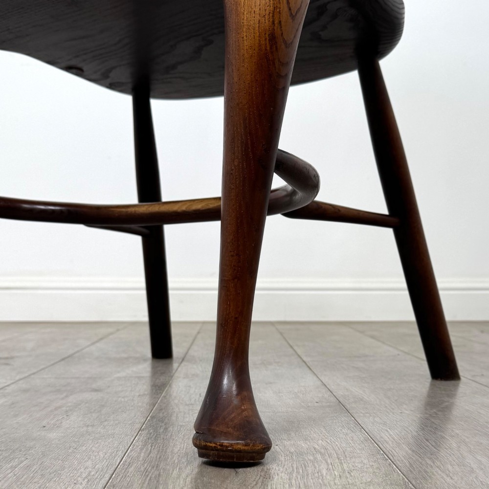 A pair of warm brown elm Windsor armchairs featuring shaped top rails, pierced back splats, spindle supports, shaped saddle seats, and front cabriole legs. View XIII