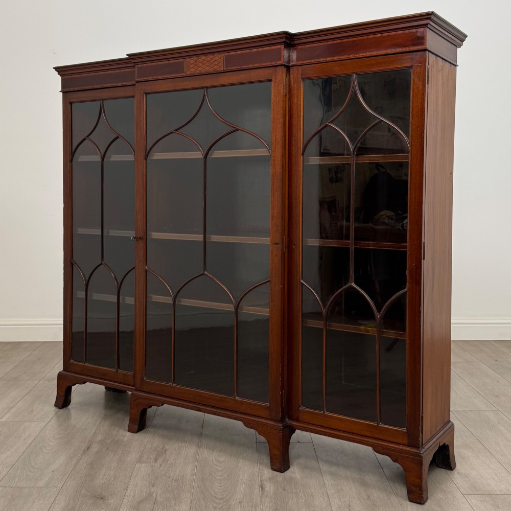 A Victorian mahogany breakfront display cabinet with three astragal glazed doors featuring gothic arch tracery and top frieze inlay. View III