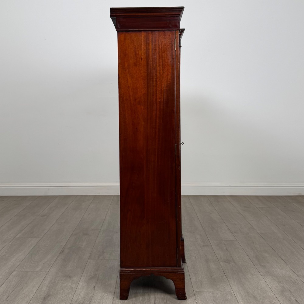 A Victorian mahogany breakfront display cabinet with three astragal glazed doors featuring gothic arch tracery and top frieze inlay. View VIII