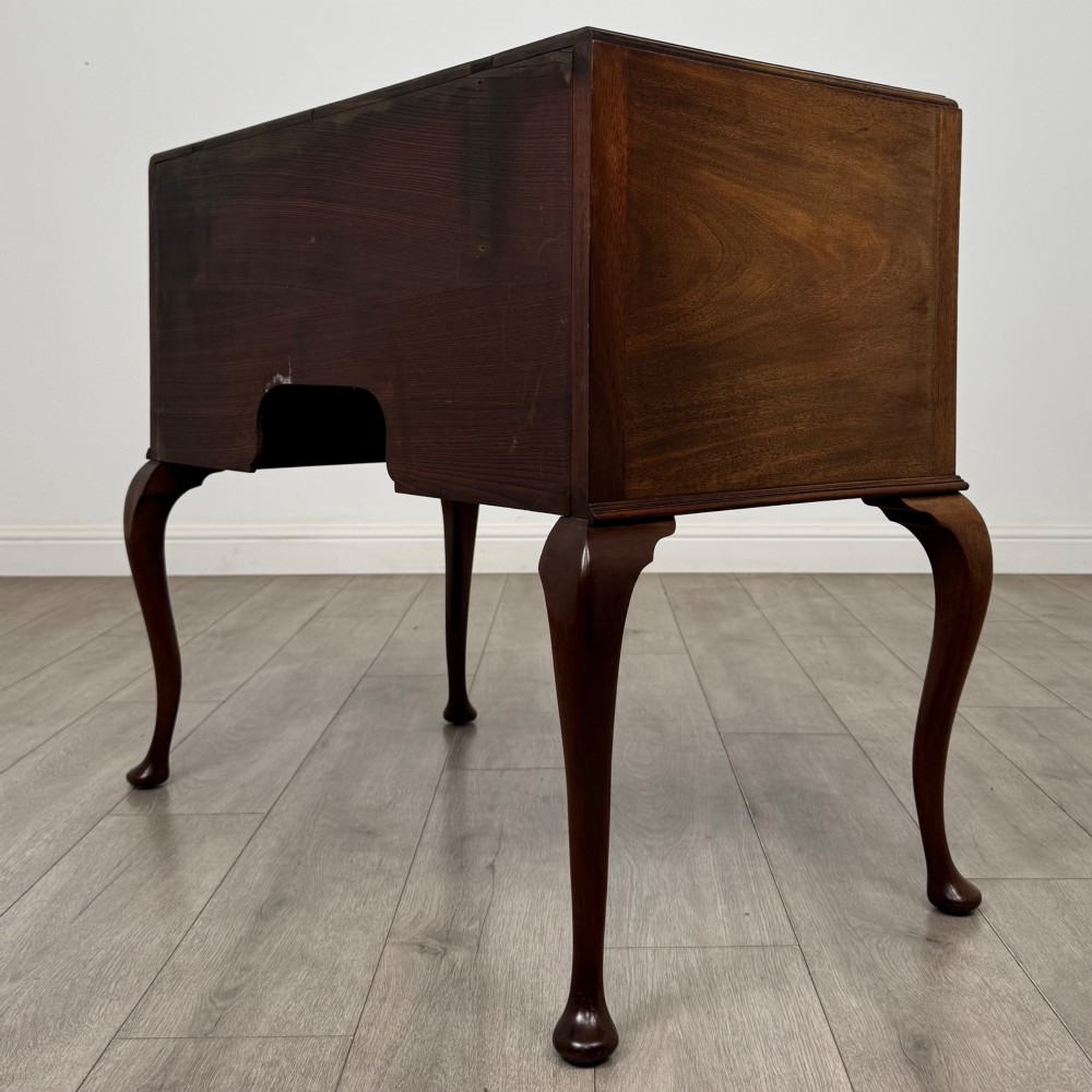 An Edwardian mahogany writing table featuring four drawers with ornamental brass drop handles, a central kneehole aperture, and four cabriole legs. View VI